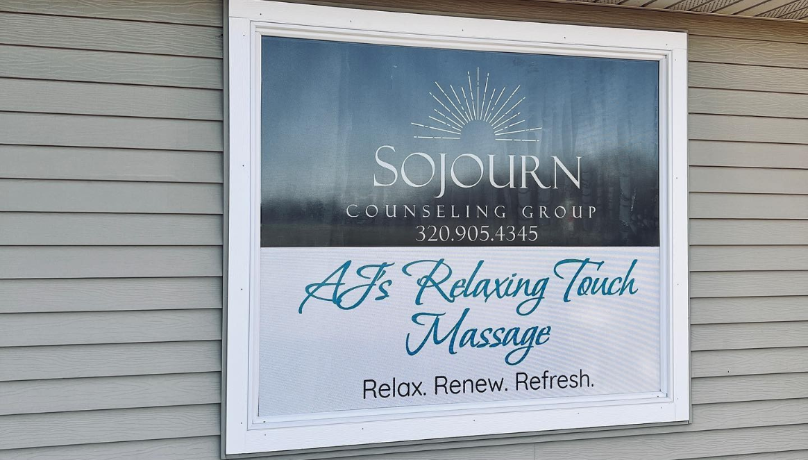 A sign on a building that says soothing touch massage.